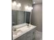 Double vanity bathroom with a large mirror and marble-look tile at 4089-B Taranto Loop # 4702-B, Myrtle Beach, SC 29579