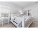 Main bedroom with a white bed frame and side table at 326 Sandridgebury Dr. # 37, Little River, SC 29566