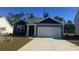 Two-toned exterior with a white garage door and landscaping at 379 Black Pearl Way, Myrtle Beach, SC 29588