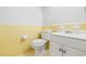 Clean bathroom with yellow tile, white vanity, and toilet at 800 9Th Ave. S # T-4, North Myrtle Beach, SC 29582