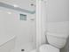 Bathroom with shower stall, toilet and built-in seat at 800 9Th Ave. S # T-4, North Myrtle Beach, SC 29582