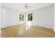Bright bedroom with hardwood floors and two windows at 800 9Th Ave. S # T-4, North Myrtle Beach, SC 29582