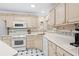 Bright eat-in kitchen with white appliances and ample cabinetry at 723 Antigua Dr., Myrtle Beach, SC 29572