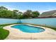 Private pool with blue-painted wall and lush grass at 723 Antigua Dr., Myrtle Beach, SC 29572