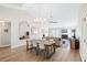 Open dining room with a farmhouse table and view to the living room at 723 Antigua Dr., Myrtle Beach, SC 29572