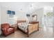Bright bedroom with wood flooring, a queen bed, and access to a private patio at 723 Antigua Dr., Myrtle Beach, SC 29572
