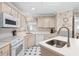 Kitchen with white appliances and corner sink. Light wood cabinets at 723 Antigua Dr., Myrtle Beach, SC 29572