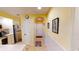 Kitchen entry hallway with yellow walls, tiled floor, and access to kitchen and other areas at 4409 Eastport Blvd. # E2, Little River, SC 29566