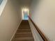 Carpeted staircase with wooden handrail leading upstairs at 492 Honeyhill Loop, Conway, SC 29526