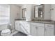 Elegant bathroom with double vanity, granite countertop, and white cabinets at 619 Springs Ave., Pawleys Island, SC 29585