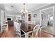 Bright dining room with table and chairs, open to living room at 619 Springs Ave., Pawleys Island, SC 29585