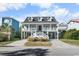 Two-story home with a spacious front porch and driveway at 619 Springs Ave., Pawleys Island, SC 29585