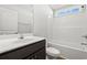 Simple bathroom with a dark wood vanity, white tub and shower at 879 Owls Nest Dr., Conway, SC 29527