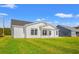 White house exterior with covered patio and grassy backyard at 883 Owls Nest Dr., Conway, SC 29527