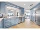 Modern kitchen with light blue cabinets, quartz countertops, and ocean view at 122 Vista Del Mar Ln. # 2-302, Myrtle Beach, SC 29572