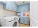 Bright laundry room with light blue cabinets and Samsung washer/dryer at 122 Vista Del Mar Ln. # 2-302, Myrtle Beach, SC 29572