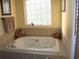 Relaxing bathroom featuring a large jetted tub and a tiled surround at 1409 Arbor Rd., Loris, SC 29569