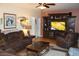 Gathering room with brown leather sofas, large TV, and wood flooring at 1409 Arbor Rd., Loris, SC 29569