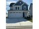 Two-story home with gray and blue siding and two-car garage at 807 Cascade Loop, Little River, SC 29566