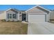 Charming one-story home with a two-car garage and well-manicured lawn at 615 Snowy Owl Way, Conway, SC 29527