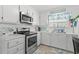 Bright kitchen features stainless steel appliances and white cabinetry at 6001-5137 S Kings Hwy., Myrtle Beach, SC 29575