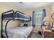 Bunk beds and a twin bed, dresser, and window with curtains at 6001-5137 S Kings Hwy., Myrtle Beach, SC 29575