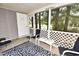 Screened porch with white chairs and a view of a pond at 1065 Pinwheel Loop # 1065, Myrtle Beach, SC 29577