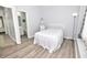 Simple bedroom with a bed, access to a bathroom, and hardwood floors at 1065 Pinwheel Loop # 1065, Myrtle Beach, SC 29577