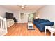 Bright living room featuring hardwood floors, comfy seating, and a large TV at 1065 Pinwheel Loop # 1065, Myrtle Beach, SC 29577