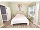 Bedroom with a queen bed, light green walls, and large window at 1065 Pinwheel Loop # 1065, Myrtle Beach, SC 29577
