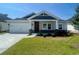 House exterior features a two-car garage and front porch at 479 Forthlin Dr., Calabash, NC 28467