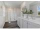 Bathroom with double vanity, grey cabinets and a shower at 2628 Riverboat Way, Conway, SC 29526