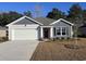 One-story home with gray siding, white garage door, and red front door at 336 Jeff Waters Circle, Longs, SC 29568