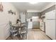 Well-equipped kitchen with gray cabinets, granite counters, and adjacent dining area at 5001 N Ocean Blvd. # 2-I, North Myrtle Beach, SC 29582