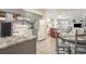 Open concept kitchen with granite countertops, gray cabinets, and adjacent dining area at 5001 N Ocean Blvd. # 2-I, North Myrtle Beach, SC 29582