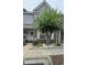 Two-story townhouse with brick and siding exterior, landscaping, and walkway at 1048 Portico Loop # 1048, Myrtle Beach, SC 29577