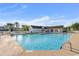 Community pool with surrounding lounge chairs and clubhouse at 1048 Portico Loop # 1048, Myrtle Beach, SC 29577