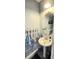 Clean bathroom with pedestal sink and round mirror at 1048 Portico Loop # 1048, Myrtle Beach, SC 29577