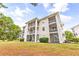 Three-story building with multiple screened porches at 472 River Oaks Dr. # 65C, Myrtle Beach, SC 29579