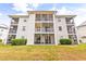 Three-story building with multiple screened porches at 472 River Oaks Dr. # 65C, Myrtle Beach, SC 29579