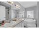 Bathroom with double sinks, a bathtub, and a window at 6001 - Mh202 S Kings Hwy., Myrtle Beach, SC 29575