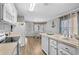 Open kitchen with white cabinets, island, and stainless steel appliances at 6001 - Mh202 S Kings Hwy., Myrtle Beach, SC 29575