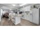 White kitchen with island, stainless steel appliances, and view to living room at 6001 - Mh202 S Kings Hwy., Myrtle Beach, SC 29575