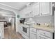 White kitchen with stove, microwave, and ample counter space at 6001 - Mh202 S Kings Hwy., Myrtle Beach, SC 29575
