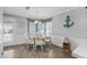 Bright dining area with white table and chairs, and nautical decor at 6001 - Mh202 S Kings Hwy., Myrtle Beach, SC 29575