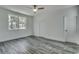 Spacious bedroom with grey wood-look floors and ceiling fan at 1817 Woodstork Dr., Conway, SC 29526