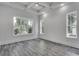 Bright bedroom with grey wood-look floors and large windows at 1817 Woodstork Dr., Conway, SC 29526