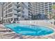 Oval outdoor pool with lounge chairs at 7200 N Ocean Blvd. # 853, Myrtle Beach, SC 29572