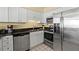 Kitchen with stainless steel appliances and granite countertops at 4719 South Ocean Blvd. # 309, North Myrtle Beach, SC 29582