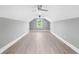 Bonus room with grey walls, hardwood floors, and two ceiling fans at 1847 Woodstork Dr., Conway, SC 29526